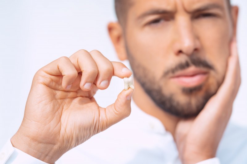 Man holding his knocked-out tooth.
