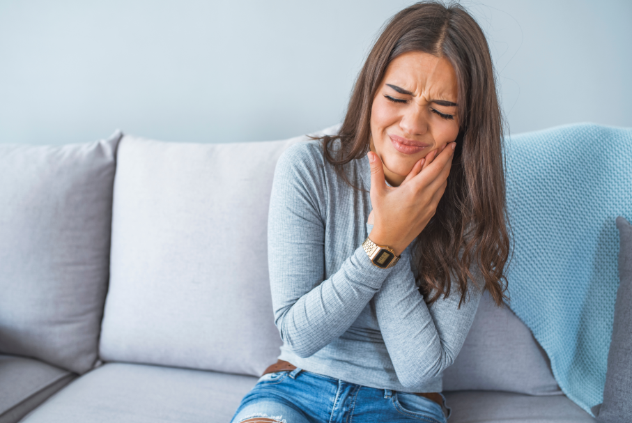Woman holding jaw in pain
